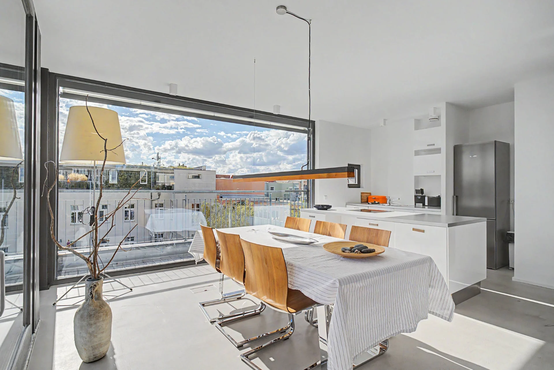 Heller Ess- und Kochbereich mit großem Fenster und Balkonblick im Penthouse am Spreeufer in Berlin-Charlottenburg — Innenaufnahme